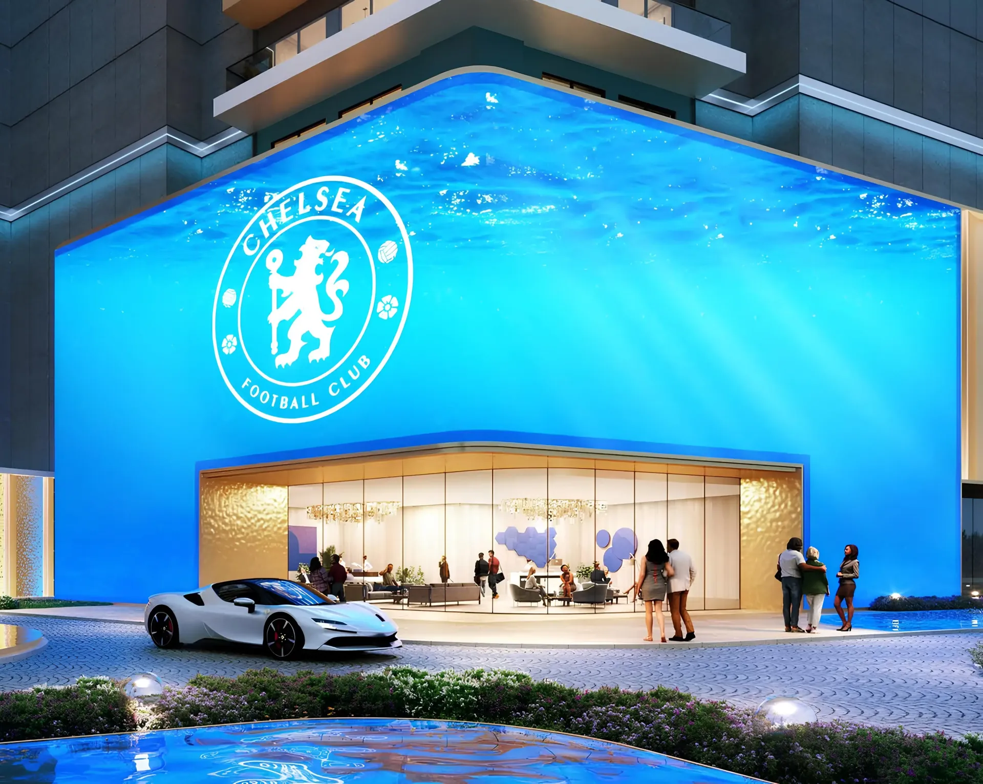Chelsea Residences 2 by DAMAC – įėjimas su Chelsea logotipu ir mėlynu vandens motyvu